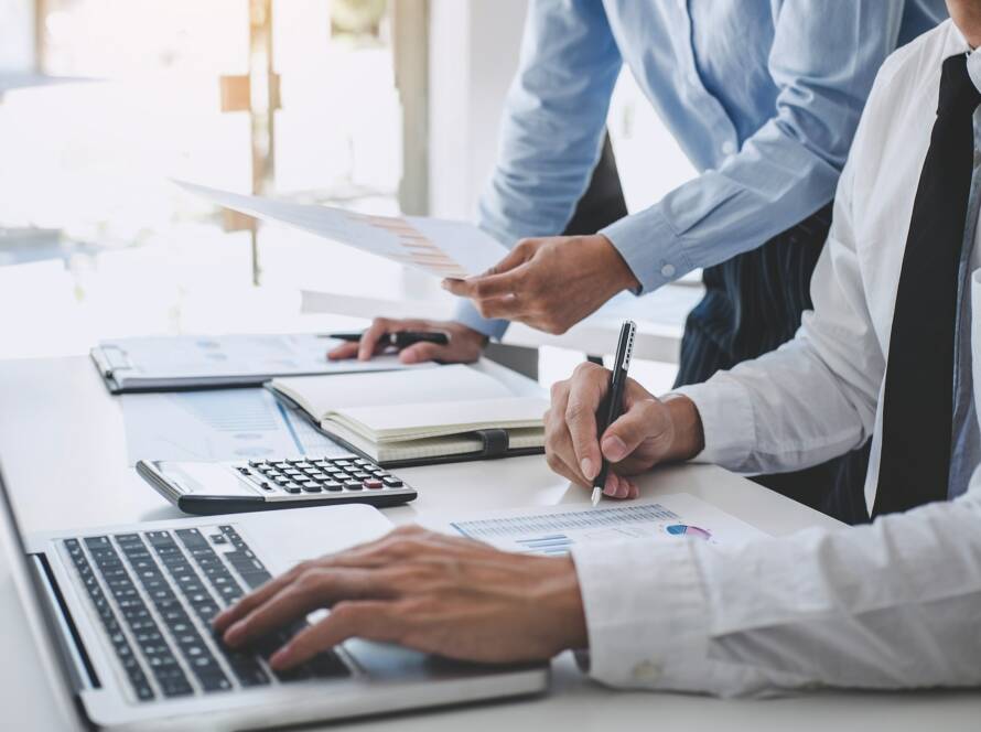Teamwork of business team consulting market growth on financial document graph report statistics